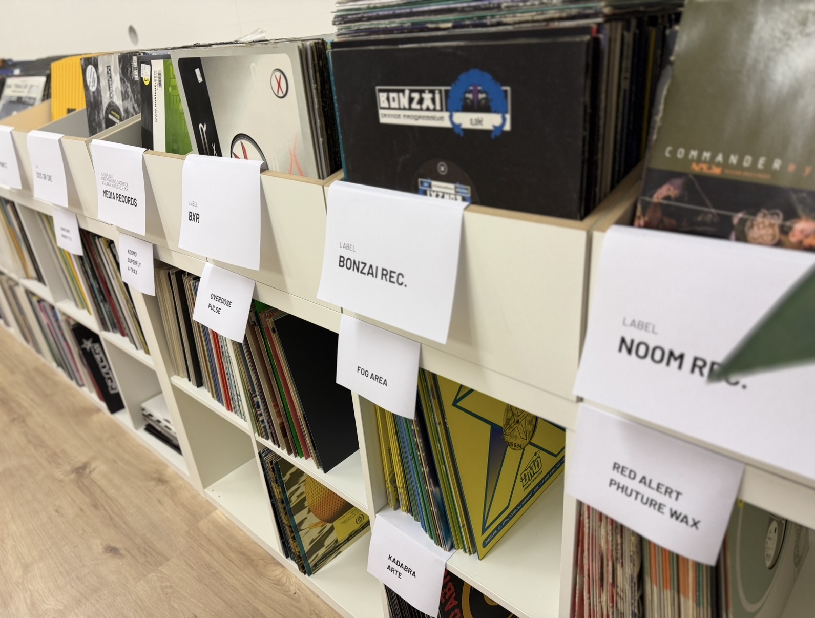 Label boxes with vinyls sorted by record label