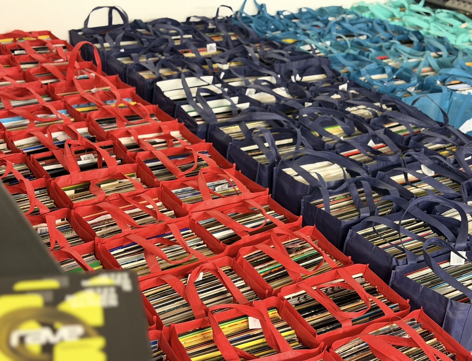 Over 20,000 techno vinyls sorted in colorful transport bags